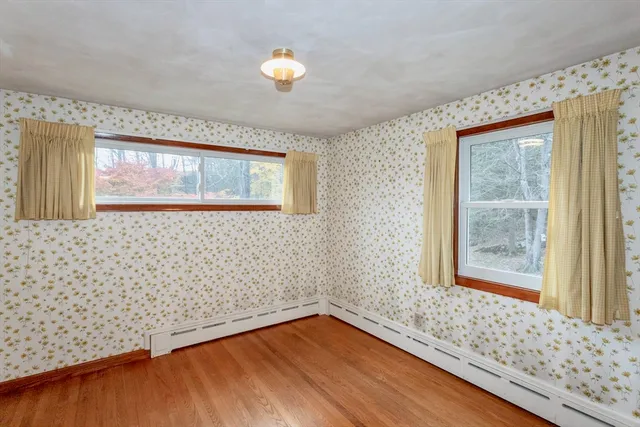 wooden floor in an empty room with a window