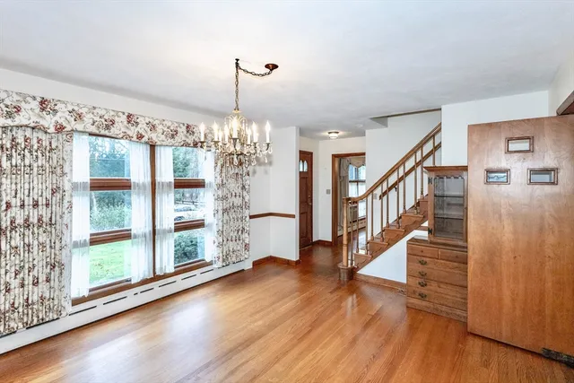 a view of a room with wooden floor staircase and windows
