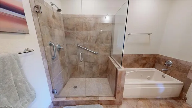 a bathroom with a tub and a shower