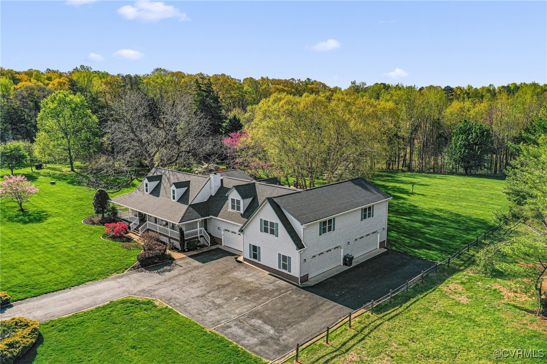 Drone / aerial view featuring a wooded view