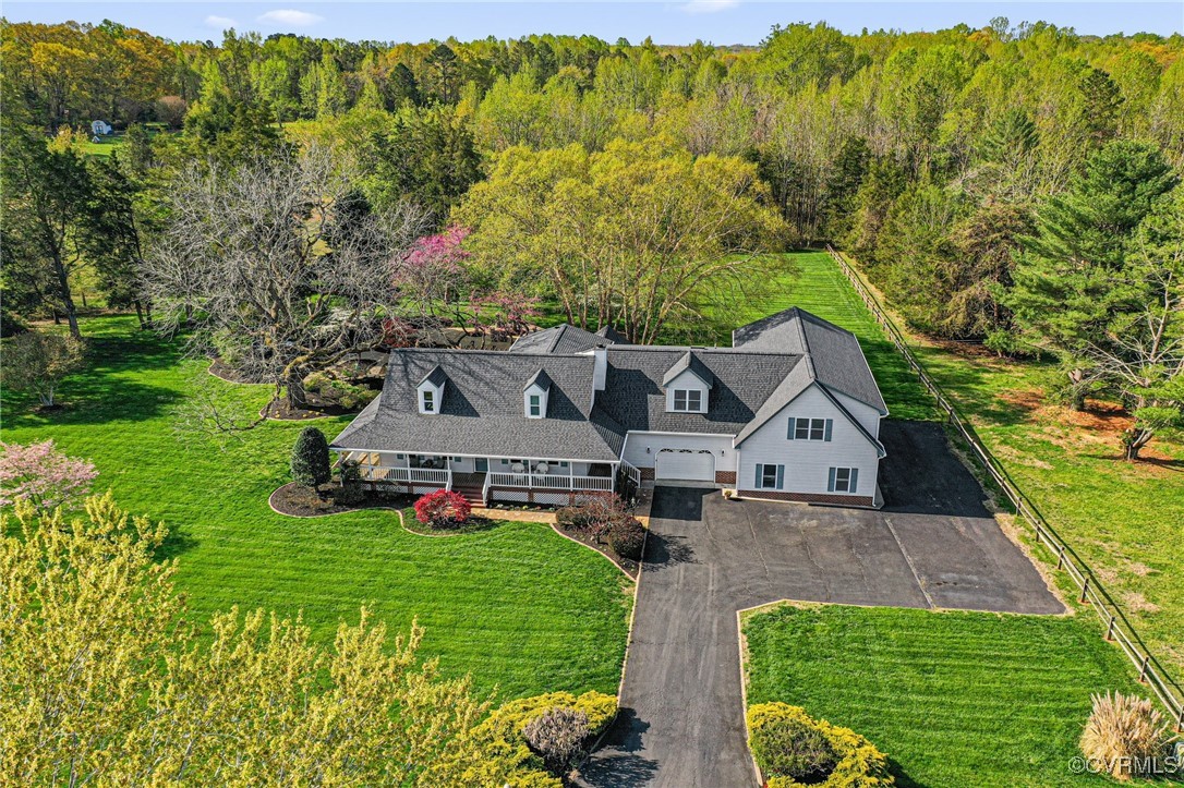 Birds eye view of property with a view of trees