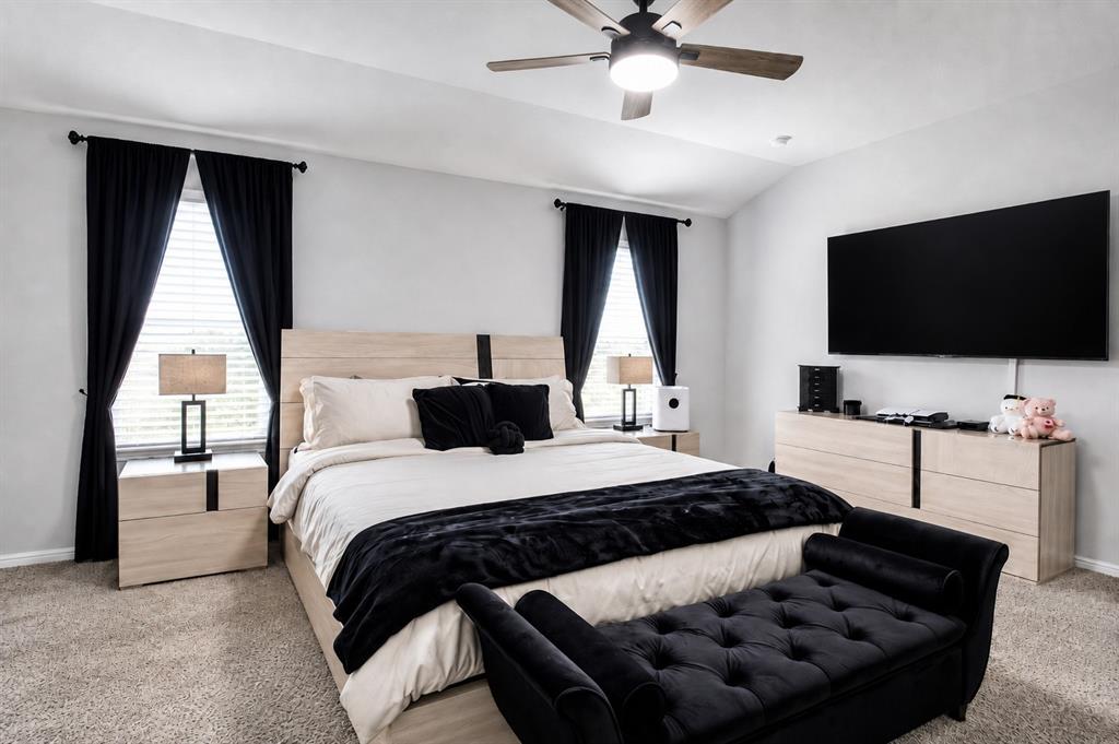 3204 Quiet Valley Road Fort Worth, TX 76123 - Photo 23 of 29 a bedroom with a bed and a flat screen tv
