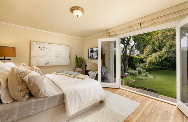 a bedroom with a bed and glass door