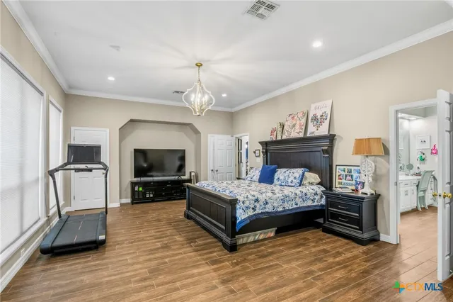 a dining room with wooden floor table and chairs