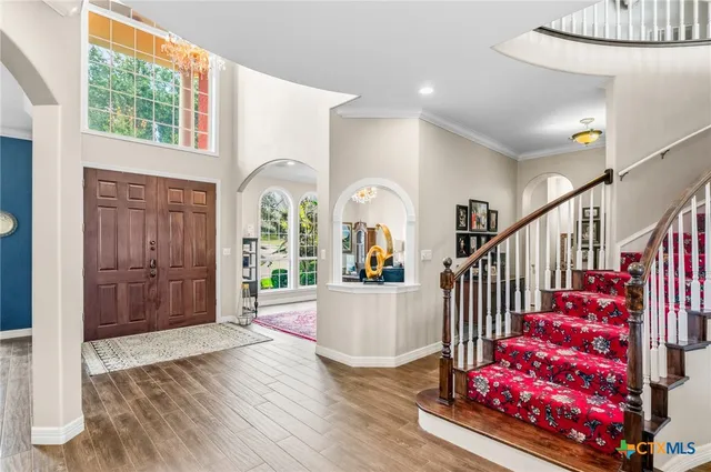 a view of entryway with wooden floor and windows
