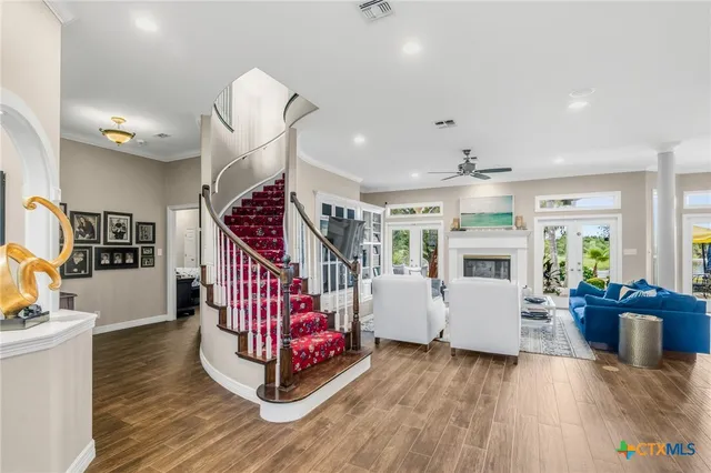 a living room with furniture and wooden floor