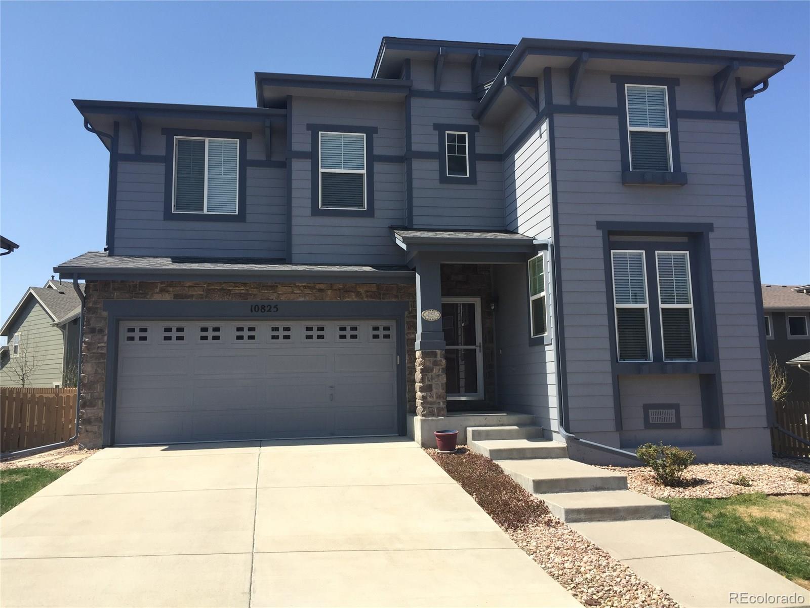 10825 Towerbridge Road Highlands Ranch, CO 80130 - Photo 1 of 24 a front view of a building
