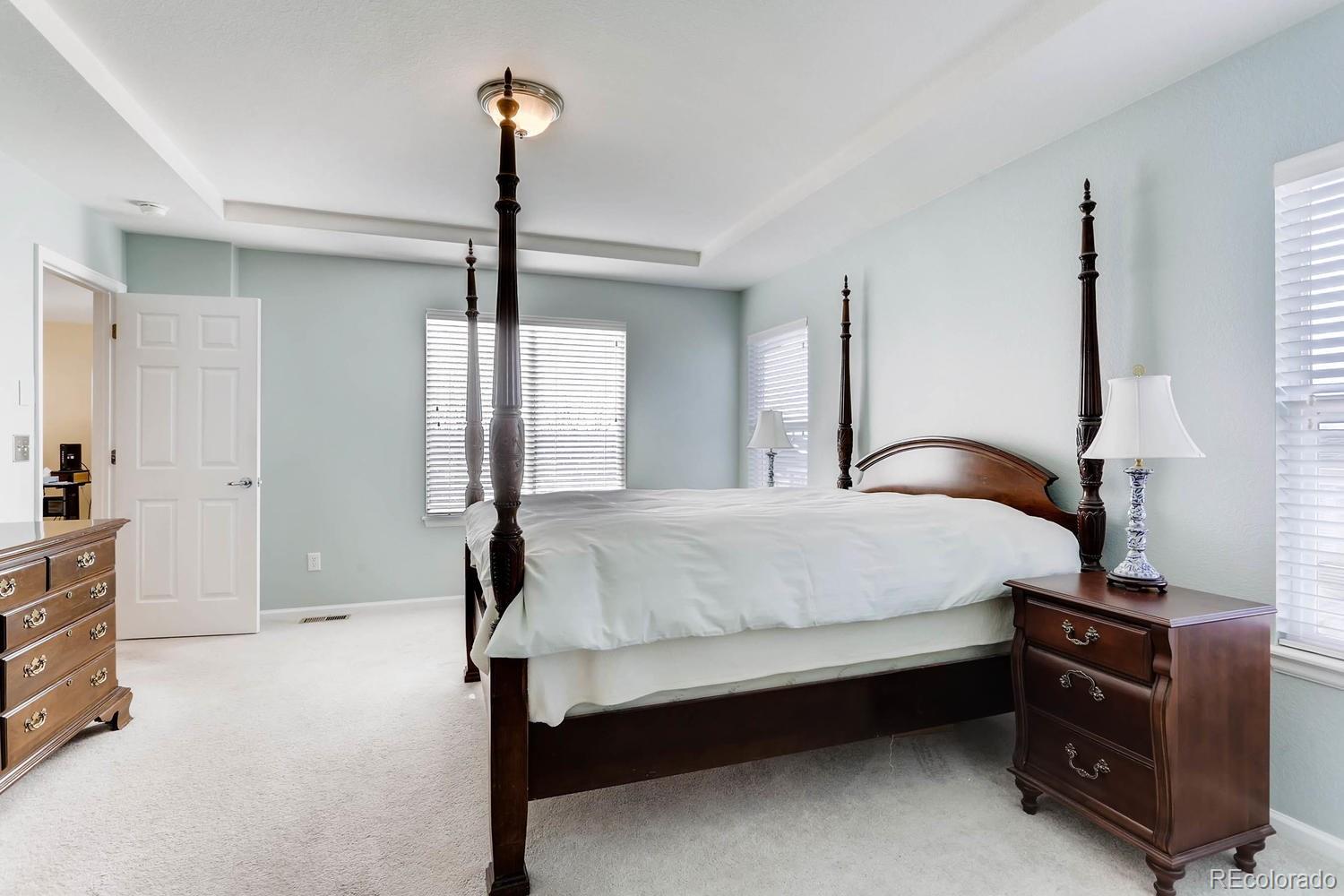 10825 Towerbridge Road Highlands Ranch, CO 80130 - Photo 14 of 24 a bedroom with bed and window