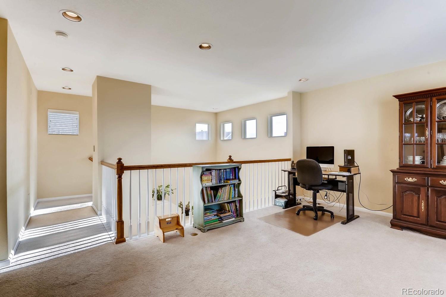 10825 Towerbridge Road Highlands Ranch, CO 80130 - Photo 16 of 24 a view of a livingroom with workspace and a window