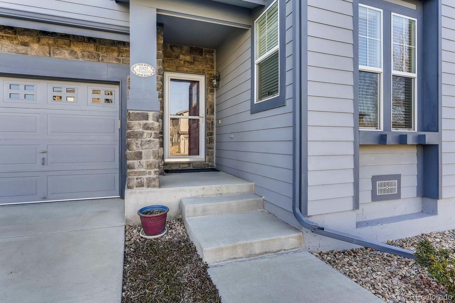 10825 Towerbridge Road Highlands Ranch, CO 80130 - Photo 4 of 24 a view of a house with a door and wooden walls