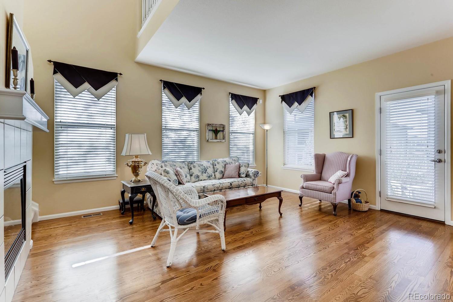10825 Towerbridge Road Highlands Ranch, CO 80130 - Photo 6 of 24 a living room with furniture and a wooden floor