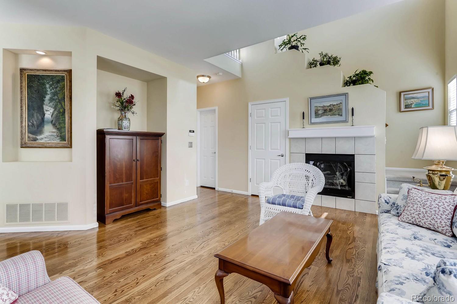 10825 Towerbridge Road Highlands Ranch, CO 80130 - Photo 7 of 24 a living room with furniture and a fireplace