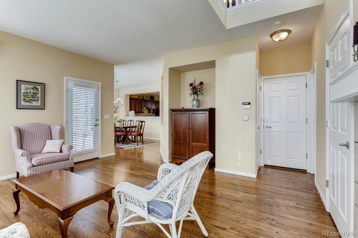 10825 Towerbridge Road Highlands Ranch, CO 80130 - Photo 8 of 24 a dining room with furniture and wooden floor