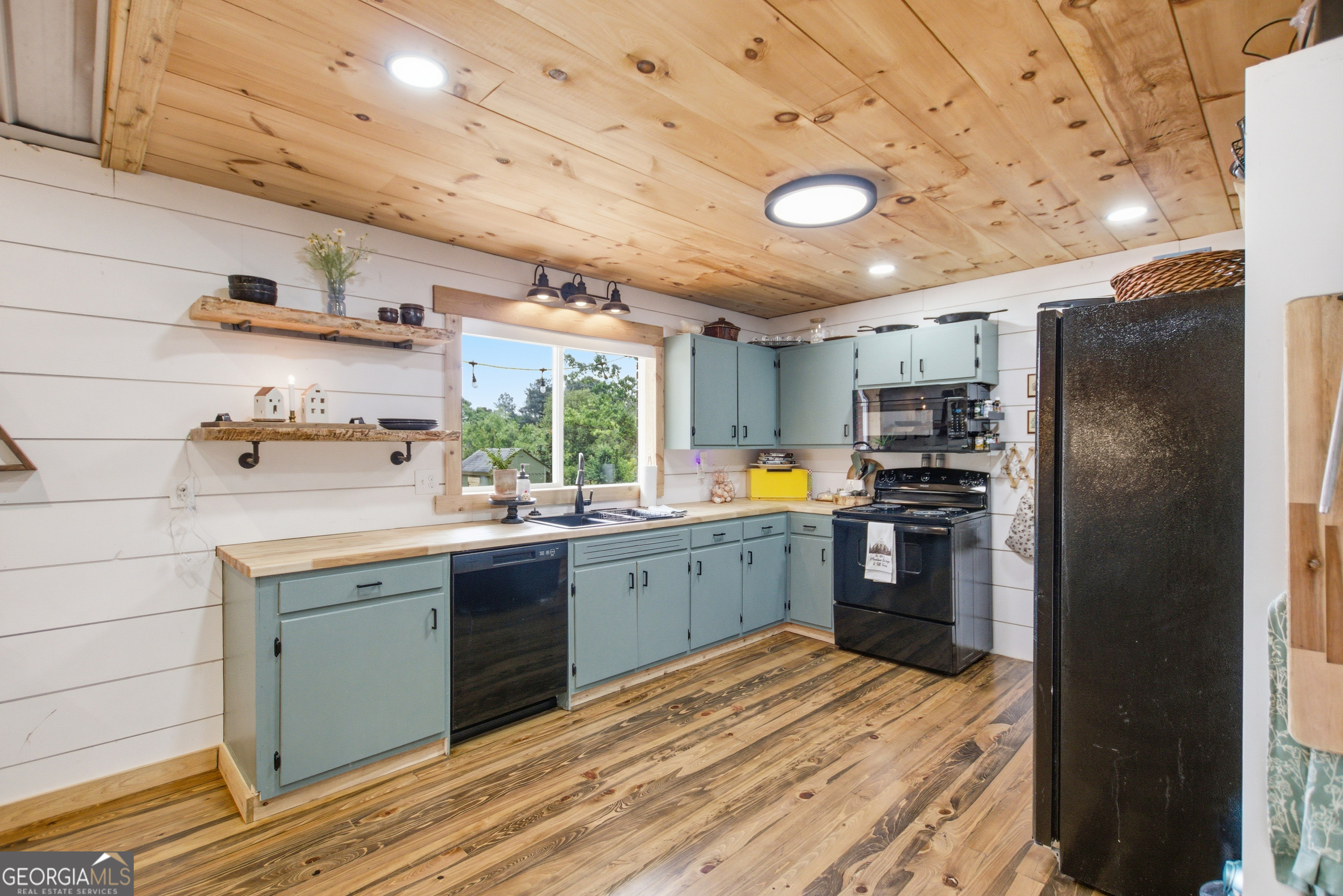 127 Akins Bridge Road Eastanollee, GA 30538 - Photo 18 of 52 a kitchen with refrigerator cabinets and wooden floor