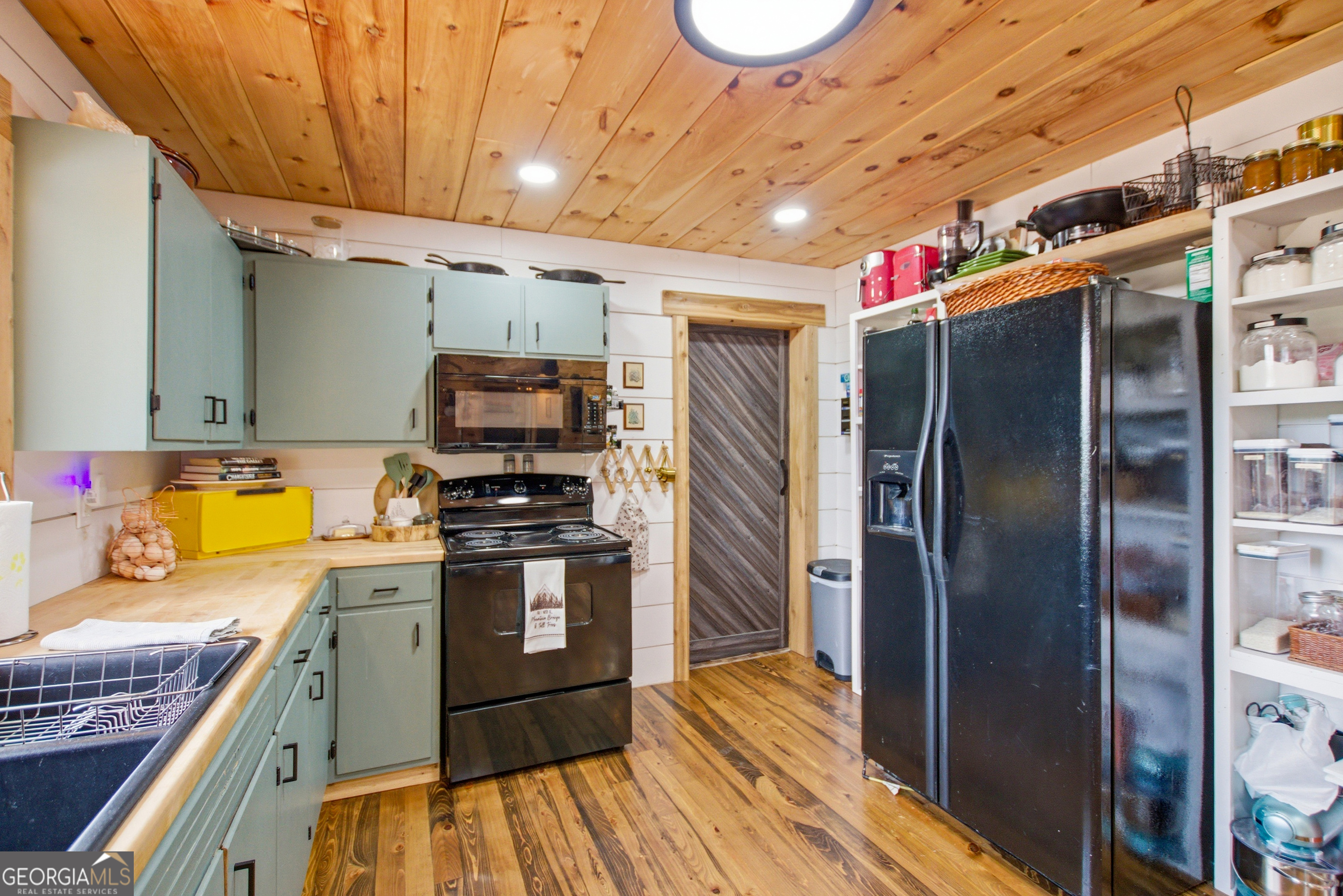 127 Akins Bridge Road Eastanollee, GA 30538 - Photo 20 of 52 a kitchen with stainless steel appliances granite countertop a refrigerator a stove and a sink with wooden floor