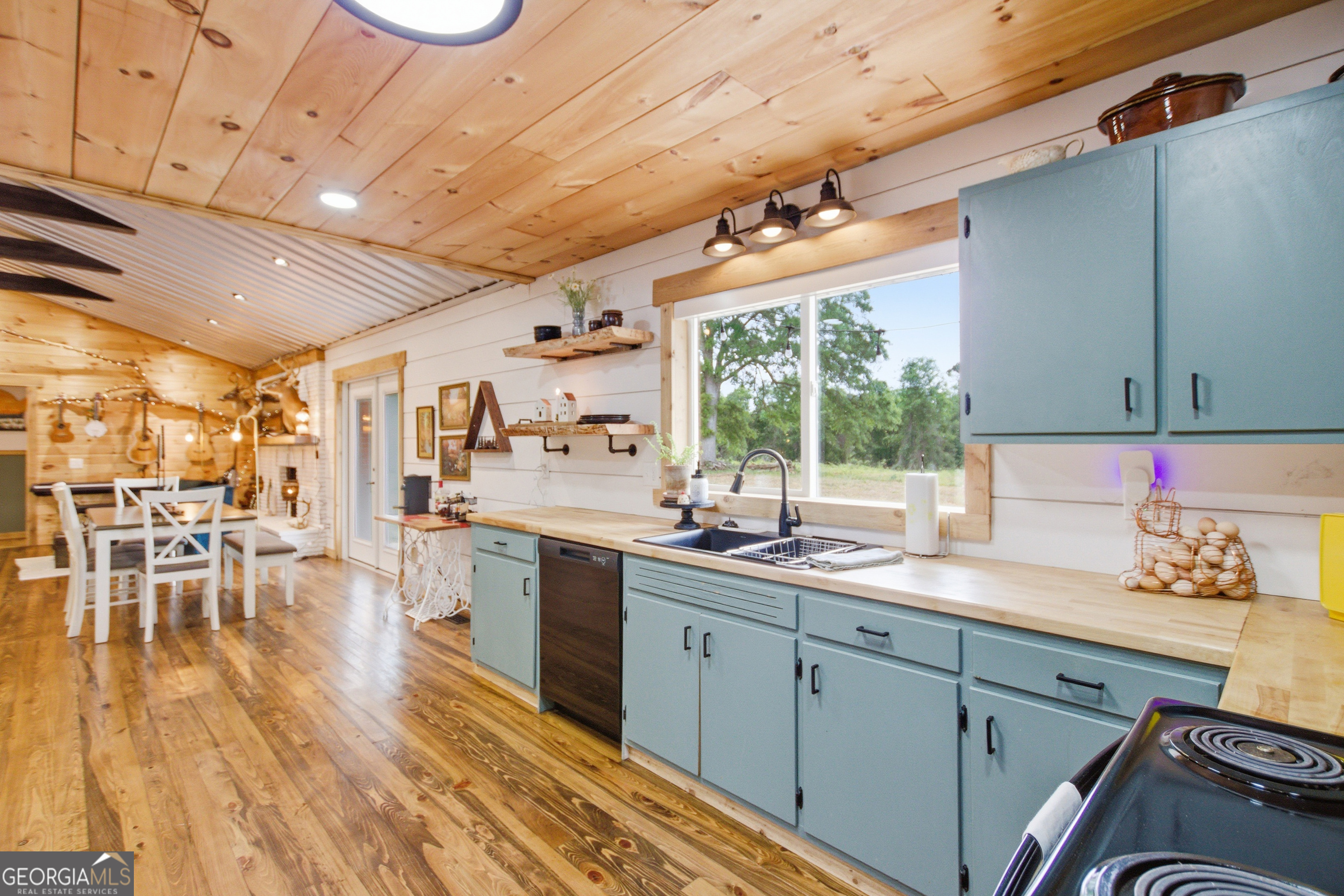 127 Akins Bridge Road Eastanollee, GA 30538 - Photo 25 of 52 a kitchen with sink cabinets and wooden floor