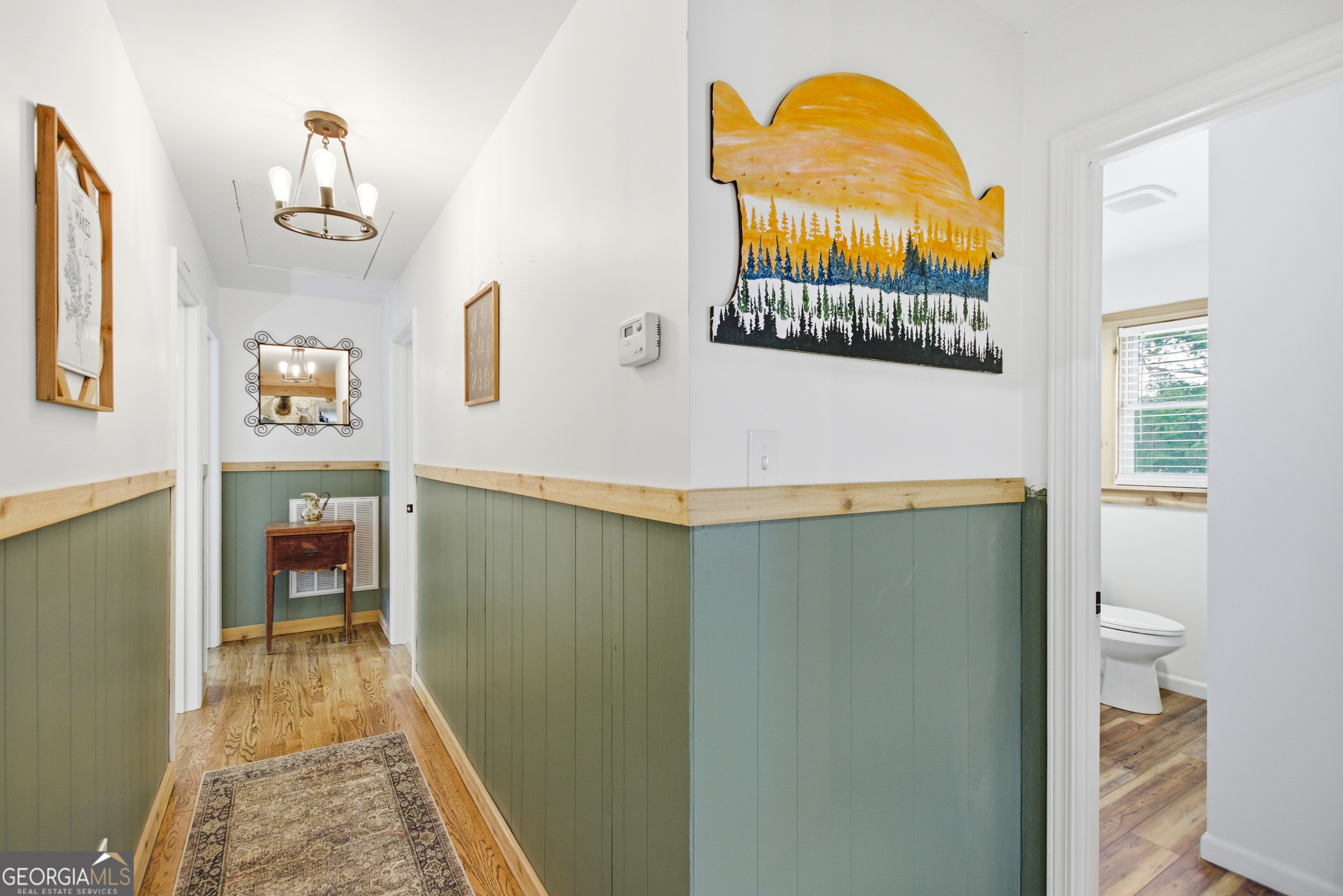 127 Akins Bridge Road Eastanollee, GA 30538 - Photo 37 of 52 a hallway with painting on the wall and a window
