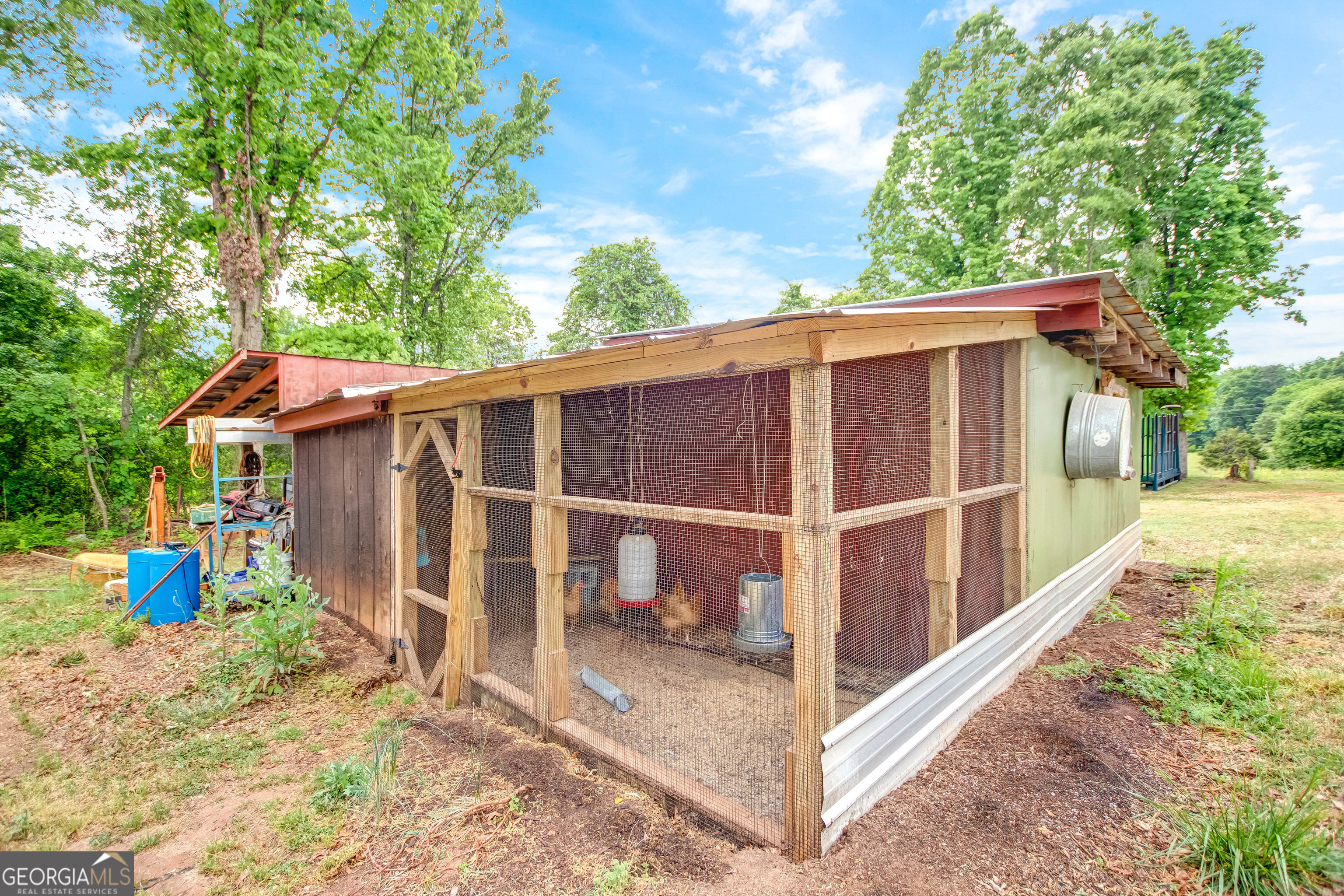 127 Akins Bridge Road Eastanollee, GA 30538 - Photo 52 of 52 a view of a wooden house with a large window and wooden fence