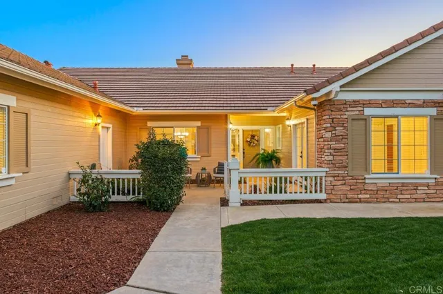 a view of a house with a yard porch and sitting area
