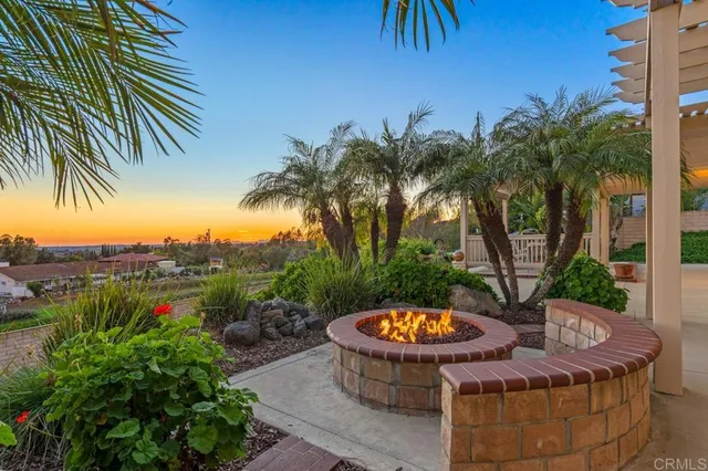 a view of a house with a patio and a yard