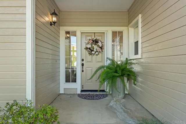a room with kitchen island granite countertop wooden floors and stainless steel appliances