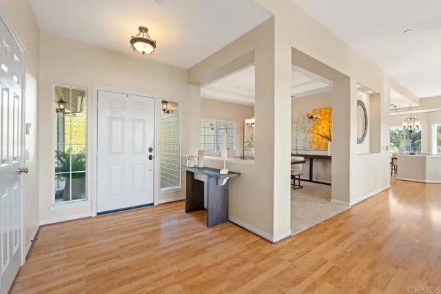 a view of a dining room with furniture wooden floor and a chandelier