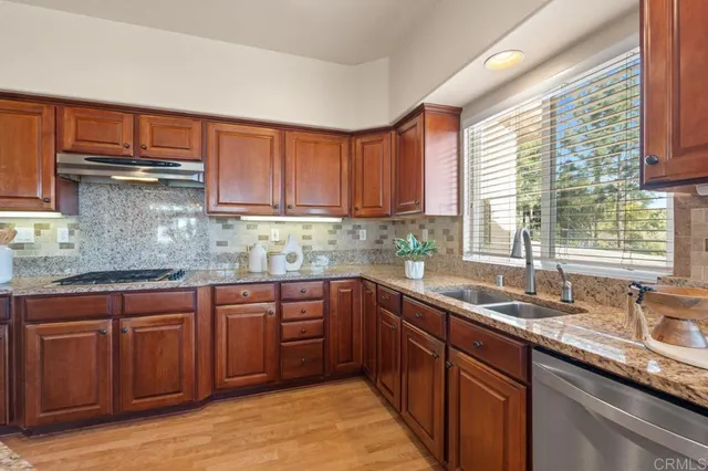 a spacious bathroom with a granite countertop double vanity and a mirror