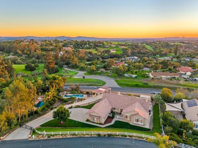 an aerial view of residential houses with outdoor space and river view