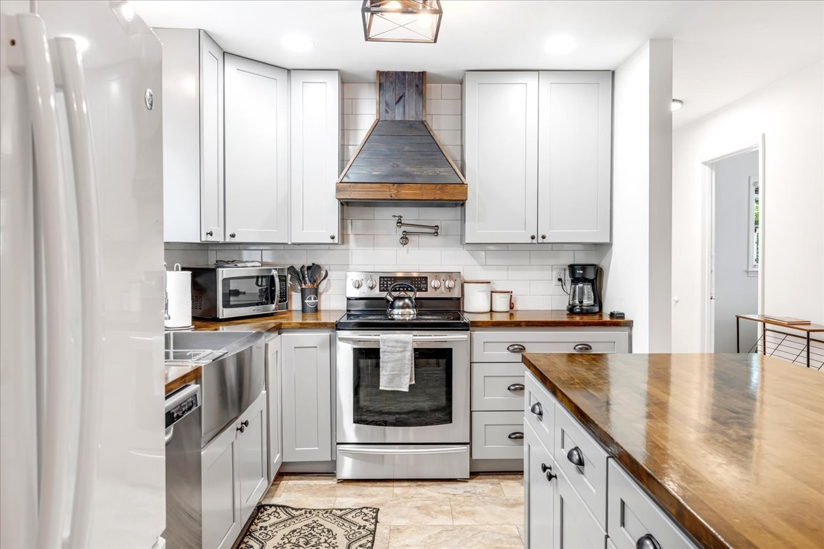 802 Evans Road Winchester, TN 37398 - Photo 11 of 43 a kitchen with stainless steel appliances granite countertop a stove a sink and a white cabinets