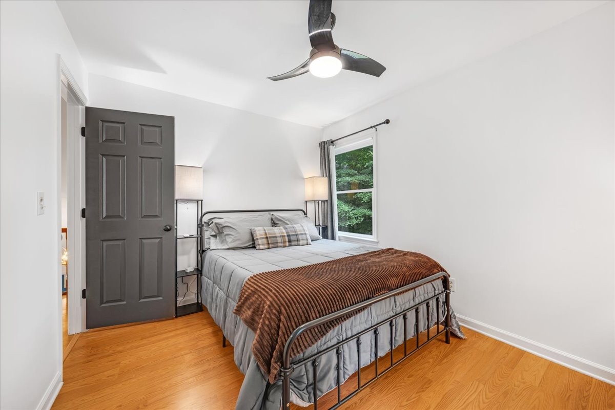 802 Evans Road Winchester, TN 37398 - Photo 28 of 43 a bedroom with a bed a chandelier and a window