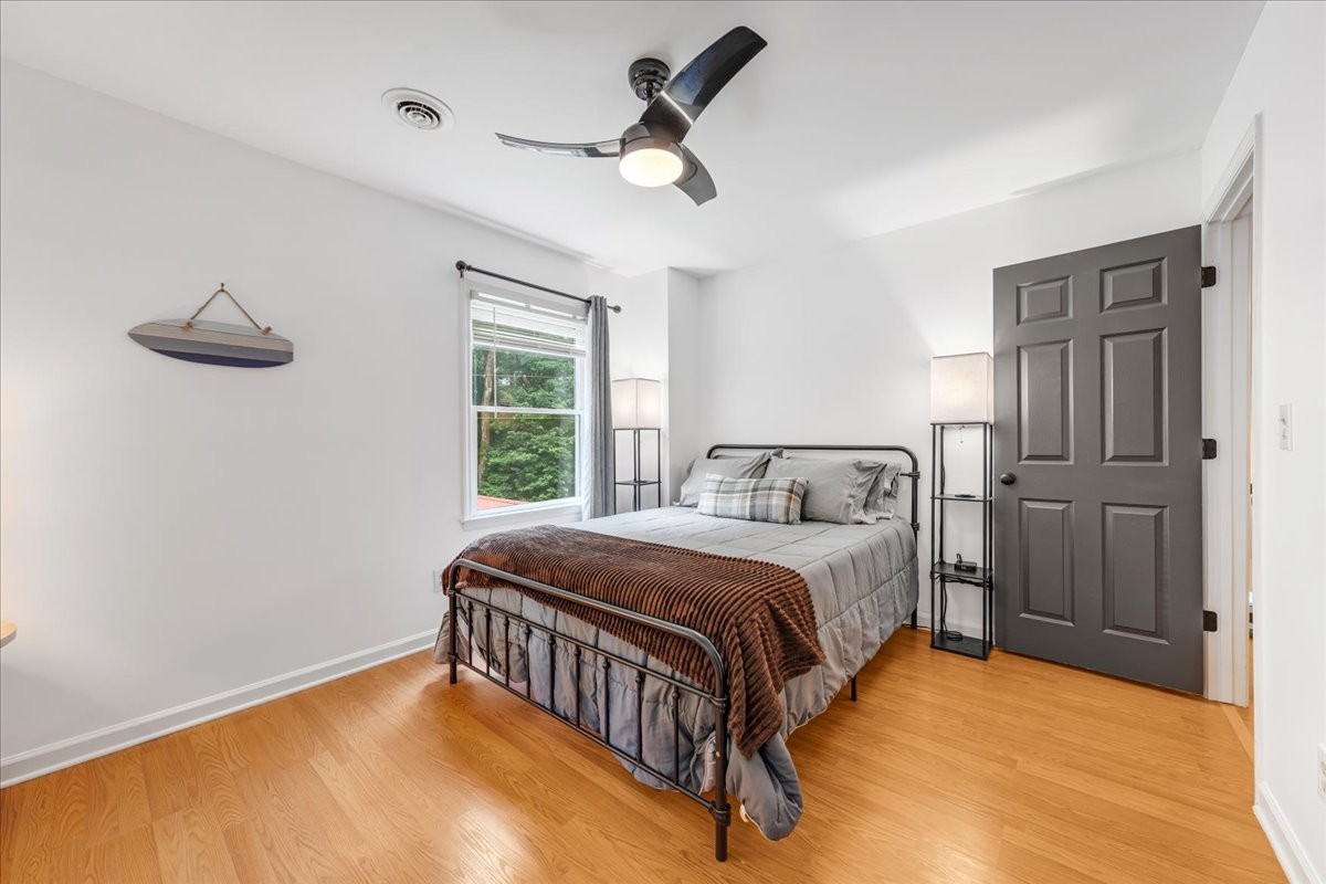 802 Evans Road Winchester, TN 37398 - Photo 30 of 43 a bedroom with a bed and a chandelier