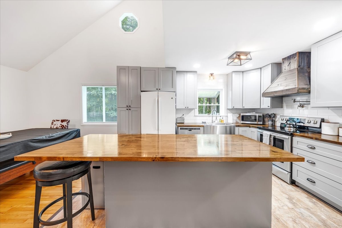 802 Evans Road Winchester, TN 37398 - Photo 8 of 43 a kitchen with stainless steel appliances granite countertop a sink a stove and a refrigerator