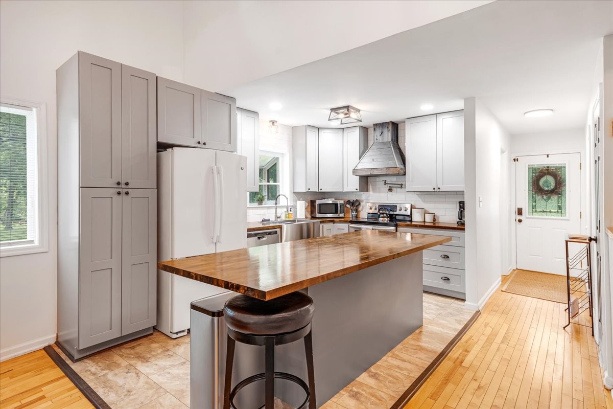 802 Evans Road Winchester, TN 37398 - Photo 9 of 43 a kitchen with stainless steel appliances granite countertop a refrigerator a sink a stove and white cabinets