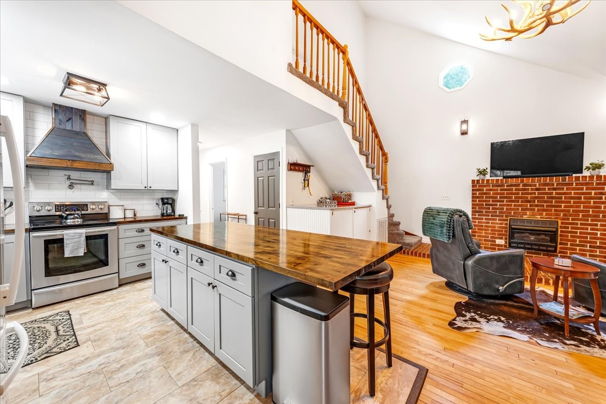 802 Evans Road Winchester, TN 37398 - Photo 10 of 43 a kitchen with stainless steel appliances granite countertop a stove and a view of living room