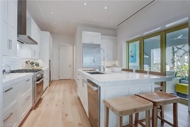 a kitchen with a stove a sink and a refrigerator