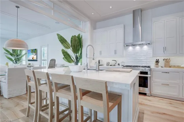a kitchen with a table chairs sink and cabinets