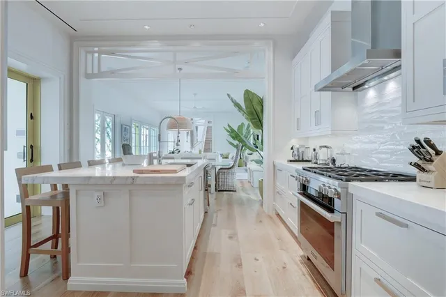 a kitchen with granite countertop a sink stove and cabinets