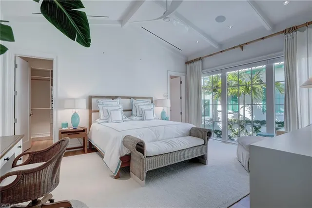 a bedroom with a bed and large window