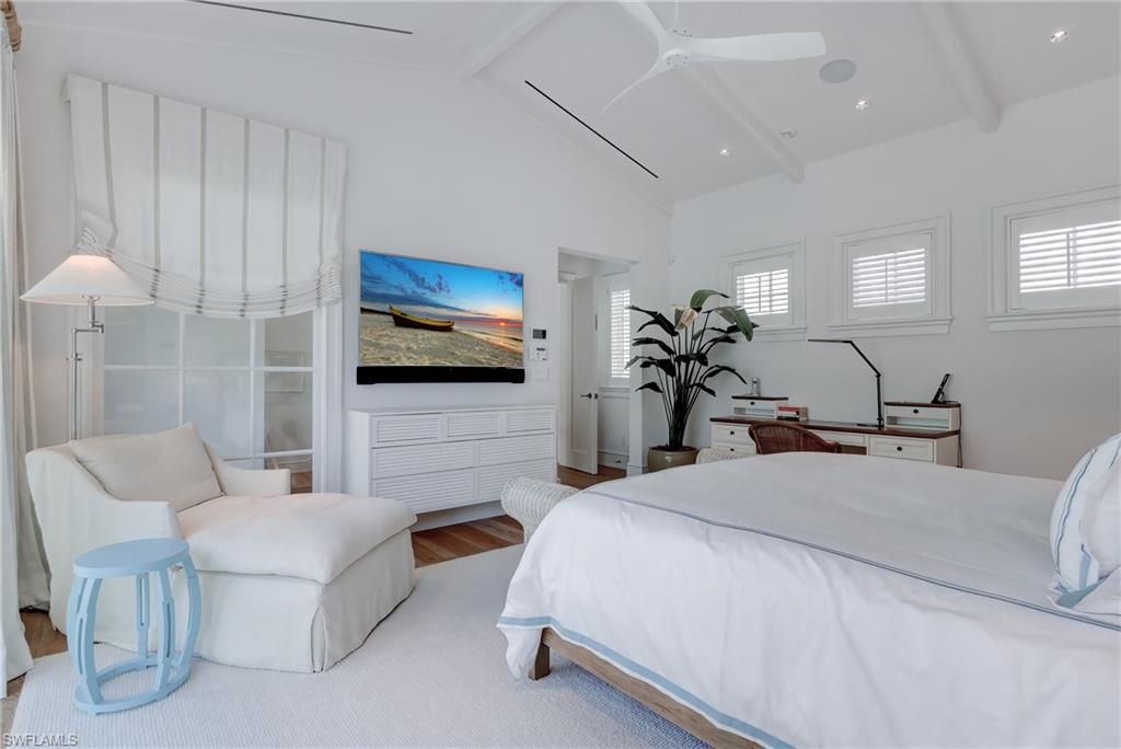 942 9th Avenue South Naples, FL 34102 - Photo 27 of 29 a bedroom with a bed a couch and a flat screen tv