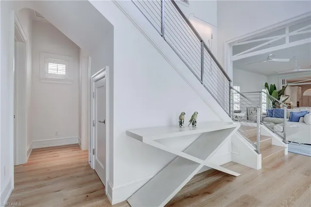 a view of hallway with dining room and wooden floor