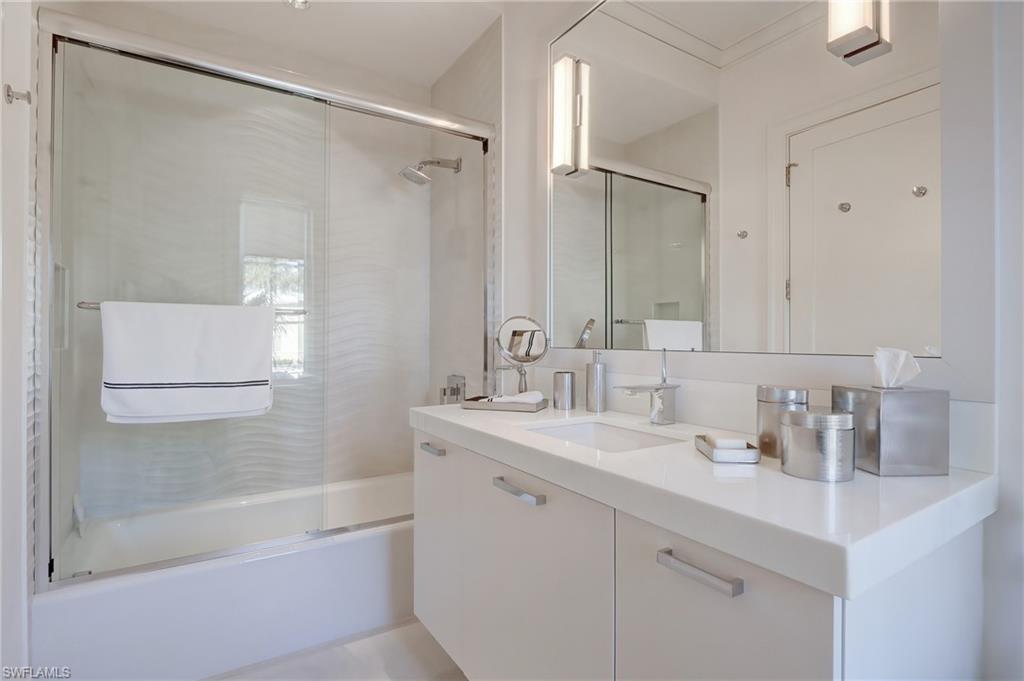942 9th Avenue South Naples, FL 34102 - Photo 10 of 29 a bathroom with a shower sink vanity and mirror