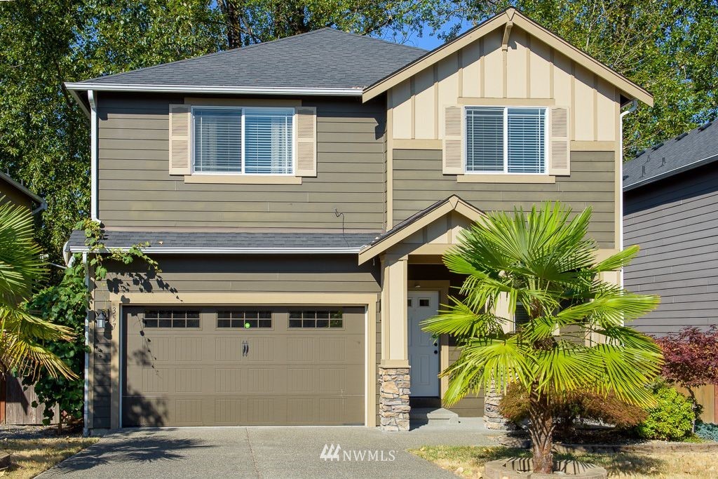357 Field Place Northeast Renton, WA 98059 - Photo 1 of 26 a front view of a house with a yard