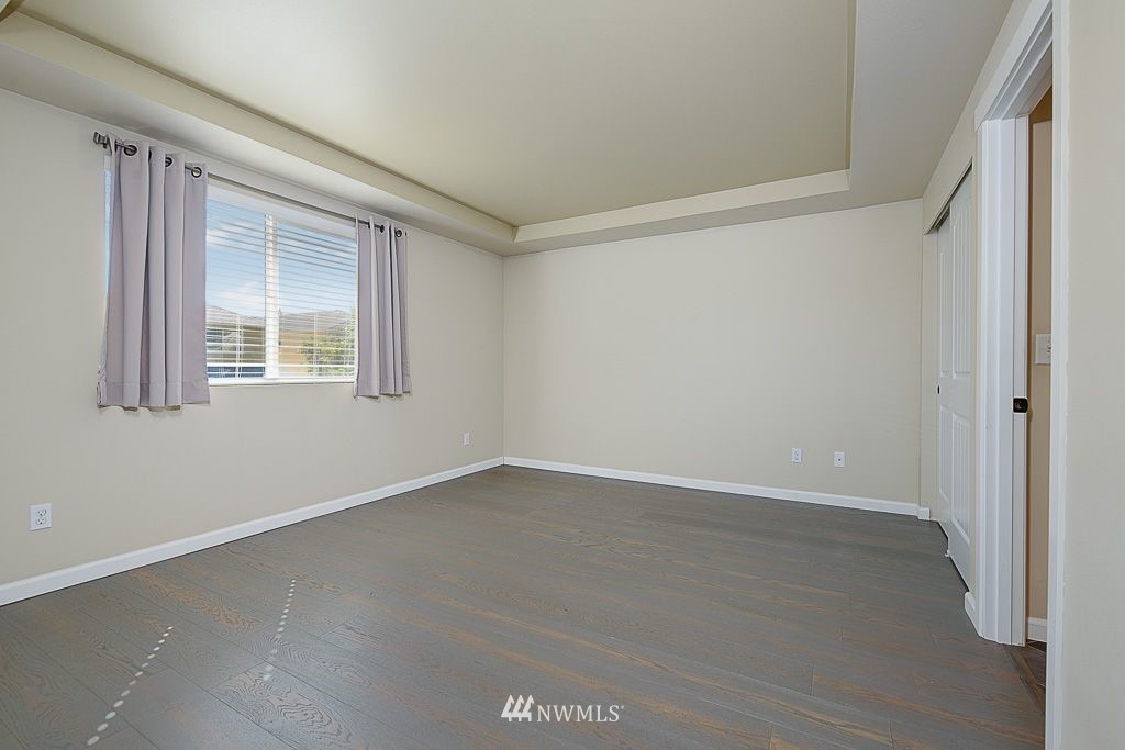 357 Field Place Northeast Renton, WA 98059 - Photo 13 of 26 an empty room with wooden floor and windows
