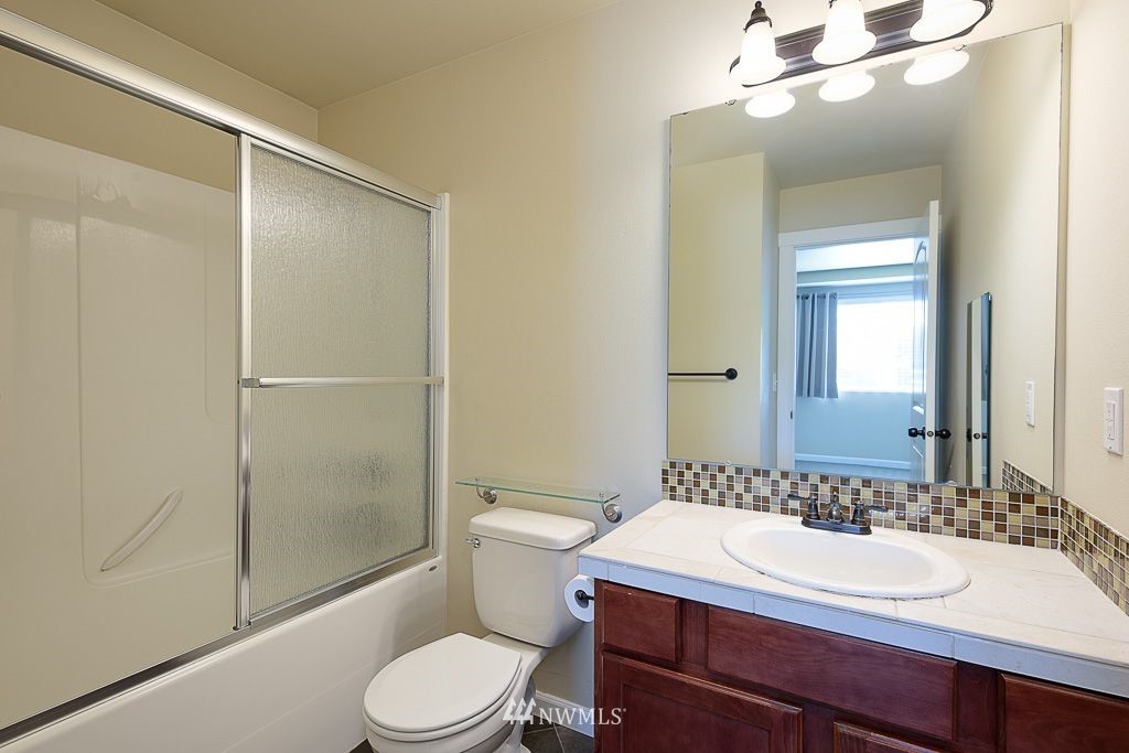 357 Field Place Northeast Renton, WA 98059 - Photo 15 of 26 a bathroom with a sink toilet and shower