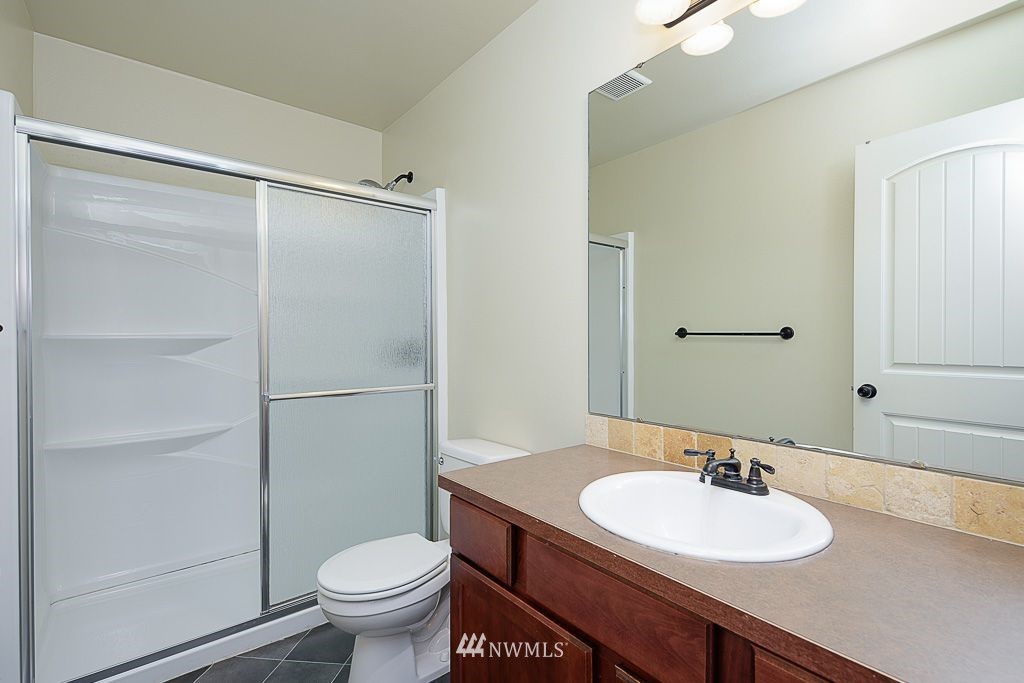 357 Field Place Northeast Renton, WA 98059 - Photo 18 of 26 a bathroom with a sink toilet and a mirror