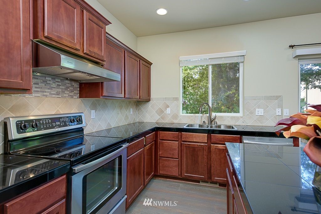 357 Field Place Northeast Renton, WA 98059 - Photo 26 of 26 a kitchen with a sink stove and cabinets