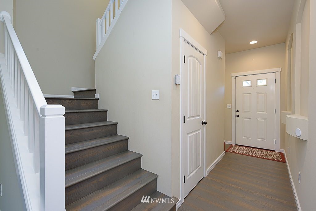 357 Field Place Northeast Renton, WA 98059 - Photo 4 of 26 a view of a hallway with wooden floor and entryway