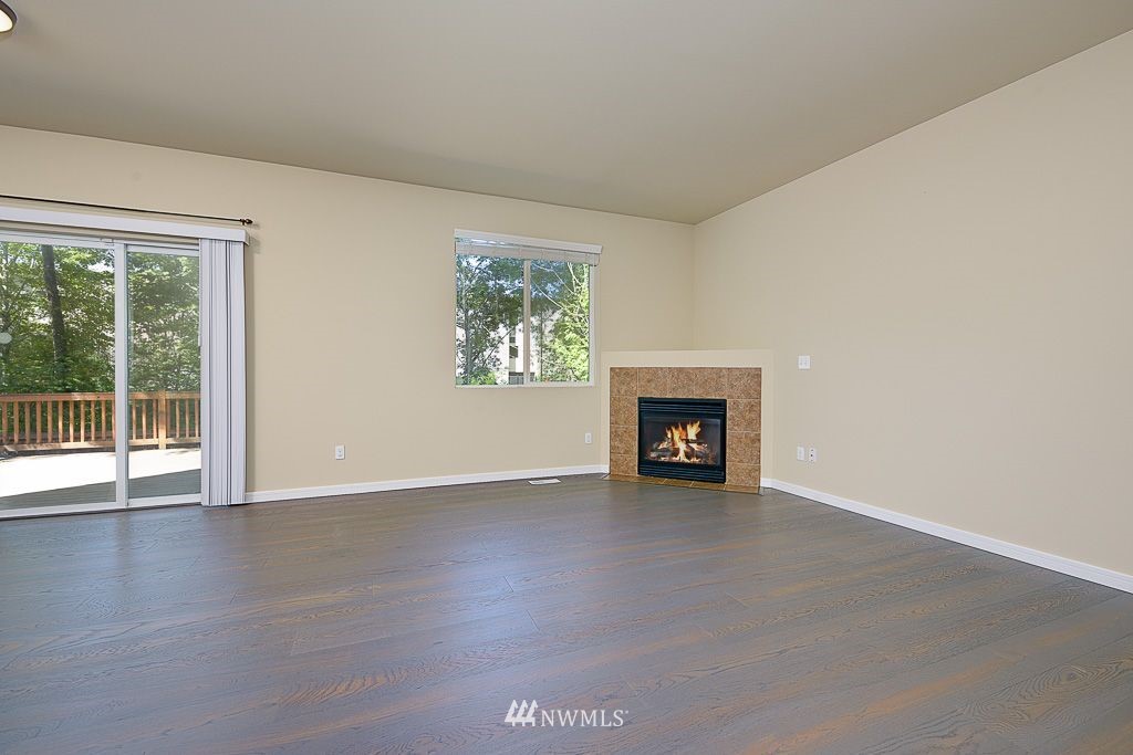 357 Field Place Northeast Renton, WA 98059 - Photo 5 of 26 an empty room with wooden floor and a window