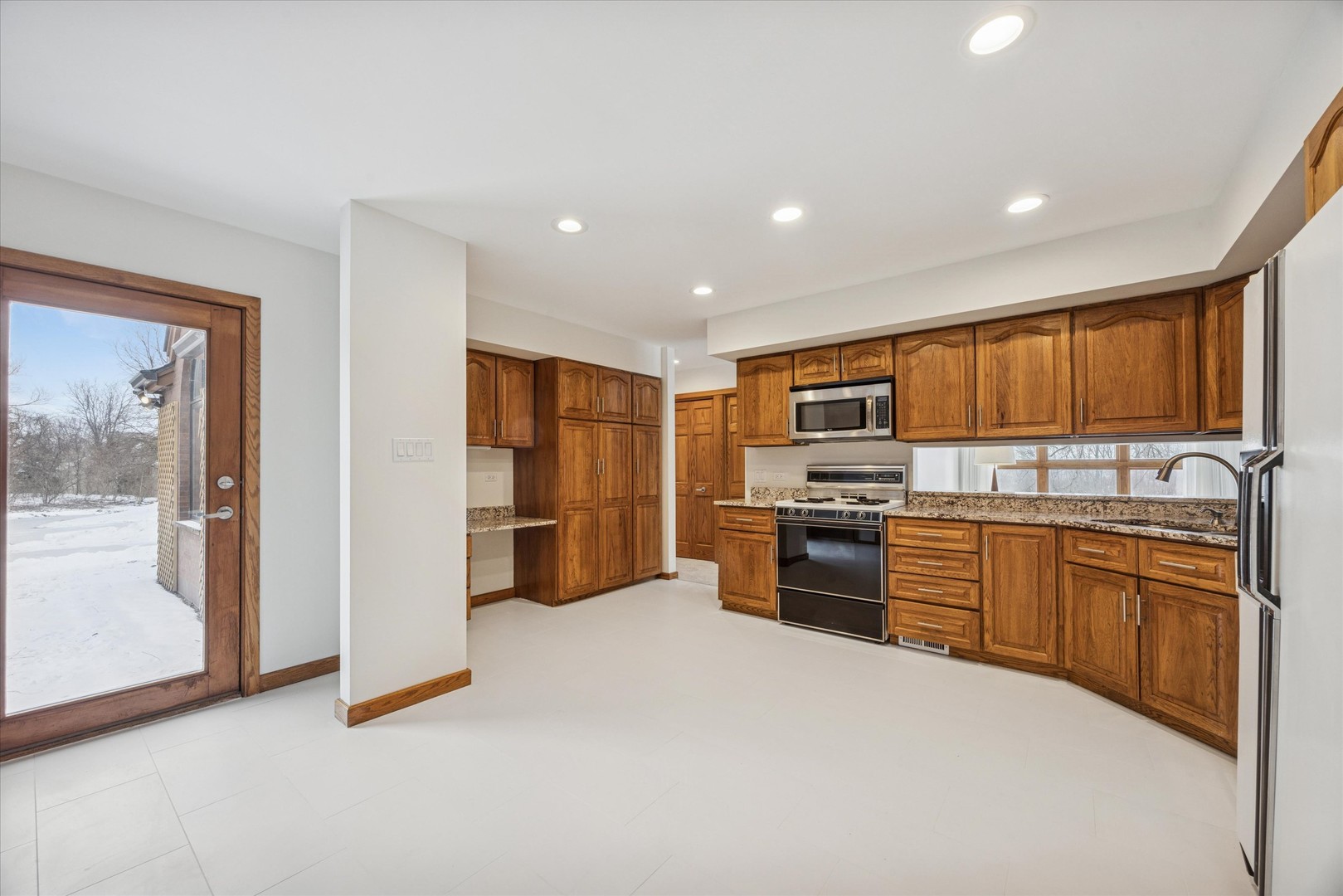 8425 Hickory Court Burr Ridge, IL 60527 - Photo 20 of 53 a kitchen with stainless steel appliances granite countertop a refrigerator stove and oven