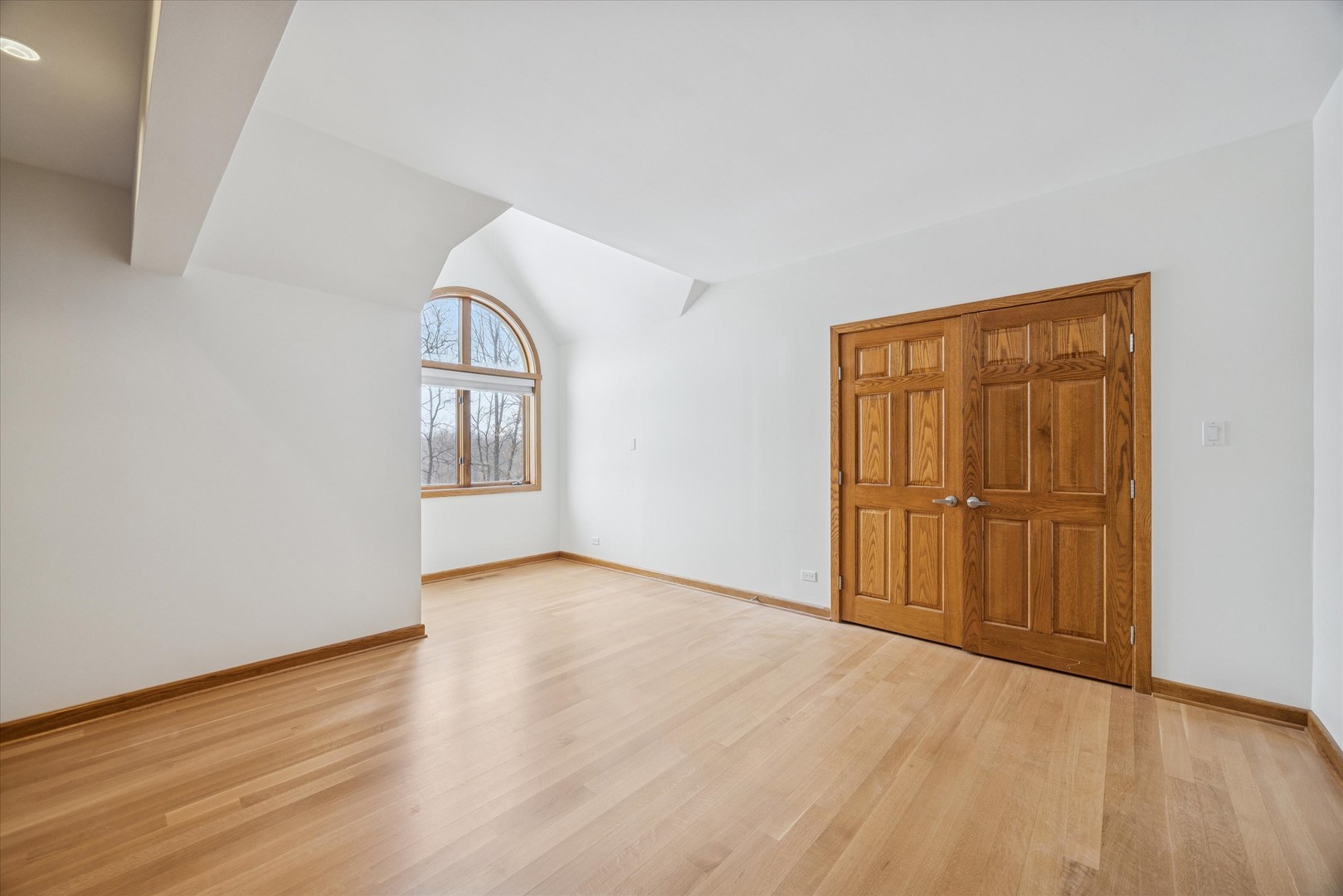 8425 Hickory Court Burr Ridge, IL 60527 - Photo 33 of 53 a view of an empty room with wooden floor and a window